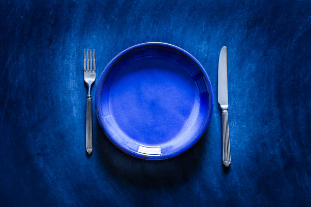 istock Blue toned place setting shot from above on dark background 867035582