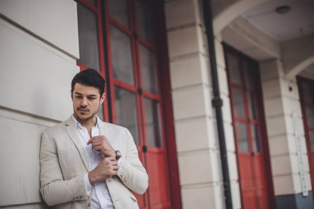 istock Businessman in suit standing on the sidewalk 867042614