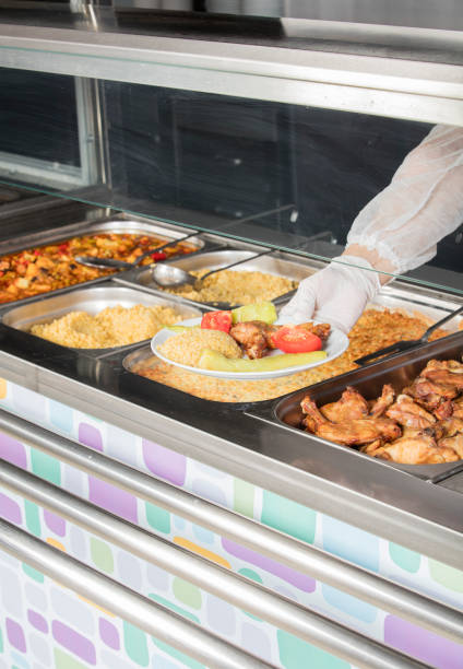 istock chef standing behind full lunch service station 867046270