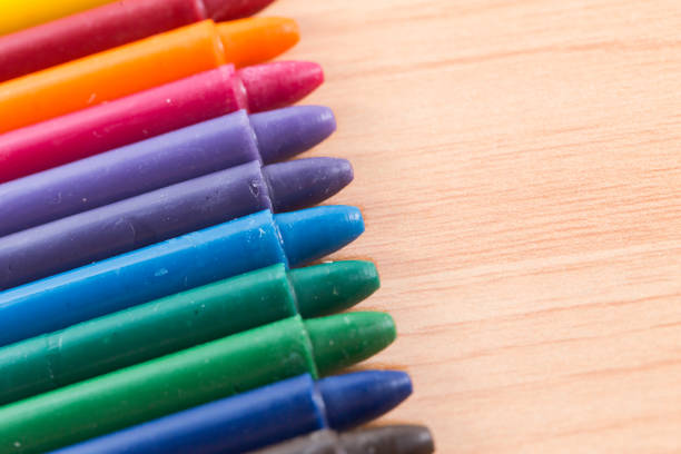 istock colorful crayon colors on wood background with copy space 867052180