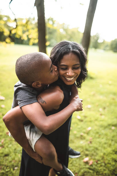 istock mother and son embracing in the park 867052700