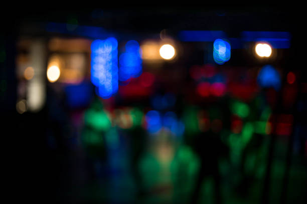 istock People dancing having fun and relax in a night club blurred background. Beautiful blurry lights on the dance floor, in the center of attention to have a rest in night club 867053522