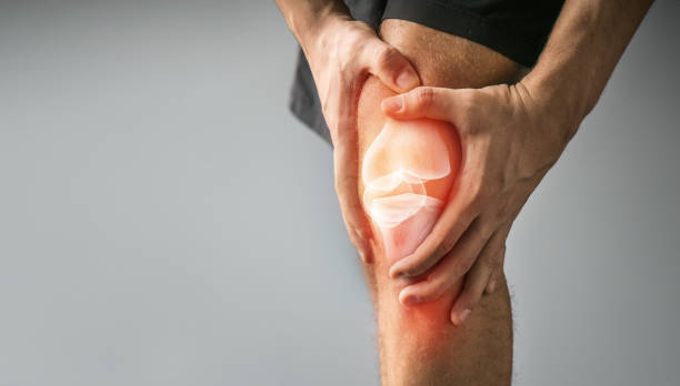 Knee trauma and joint pain-Sports injuries Joint pain, sports injuries, At gym, damaged section, Sportsman, knee bone injury, sports accidents standing had to knee pose stock pictures, royalty-free photos & images