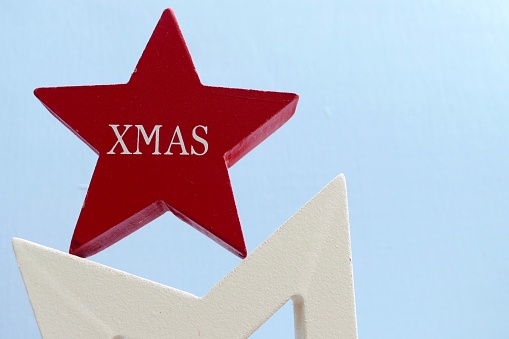 Red wooden christmas star on blue background