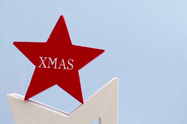 istock Red wooden christmas star on blue background 867061632
