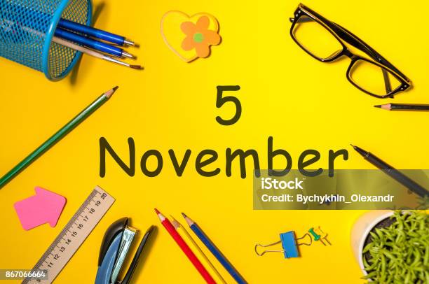 November 5th Day 5 Of Last Autumn Month Calendar On Yellow Background With Office Supplies Business Theme Stock Photo - Download Image Now