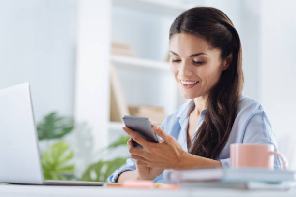 istock Positive self employed woman using her smartphone 867066690