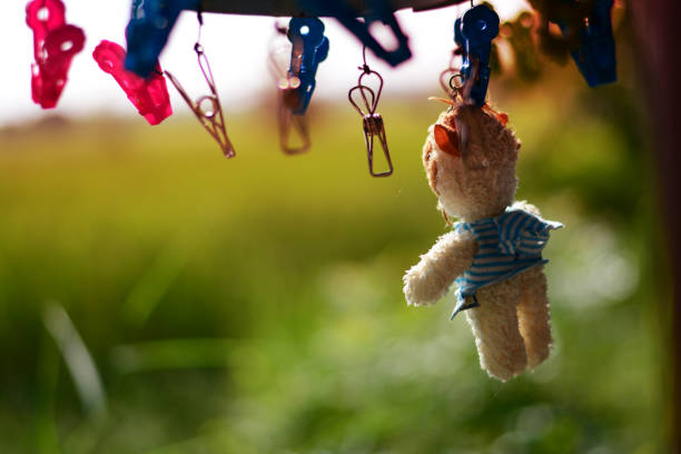 istock drying  doll by hanging with plastic cloth clamp and sunlight at afternoon 867068092