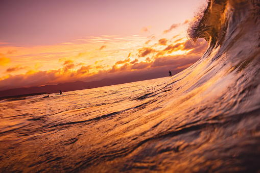 Ocean wave breaking down at sunset or sunrise time. Wave and with warm sunset or sunrise colors