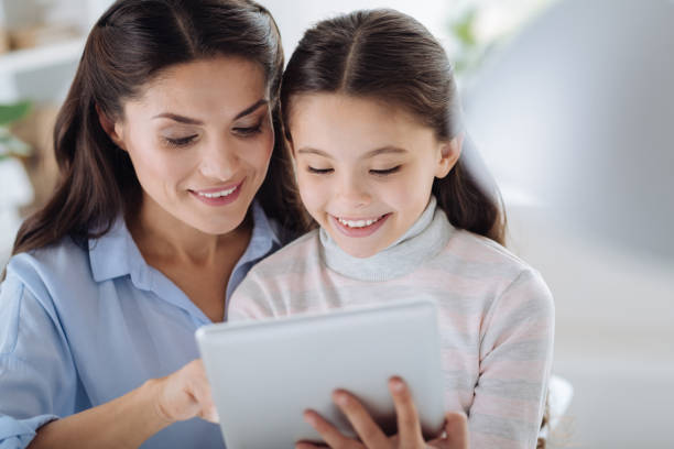 istock Delighted positive girl holding a tablet 867068836