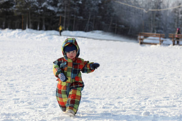 istock Toddler walking in winter park 867071230