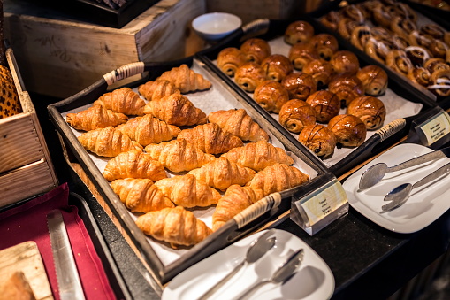 Croissants on a wooden tray in the buffet line