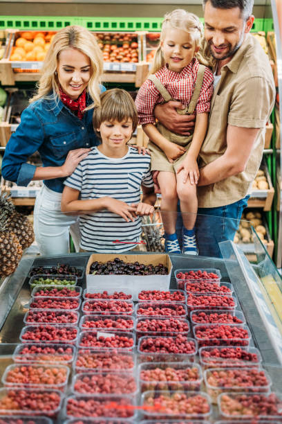 istock family choosing berries in supermarket 867075452