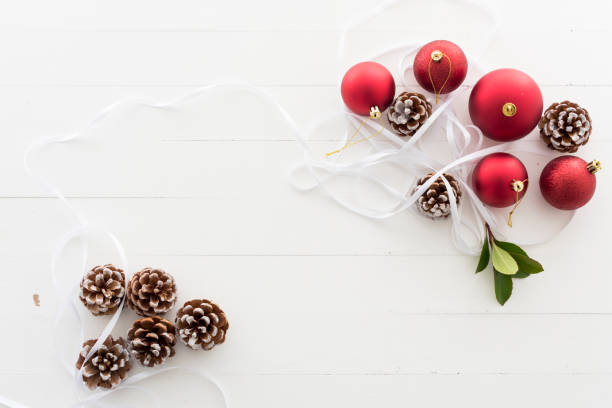 istock Christmas baubles and pine cones on background 867078996