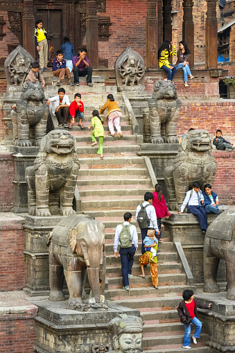 People relax at the landmark Nyatapola Temple in Bhaktapur, Nepal, near Kathmandu.