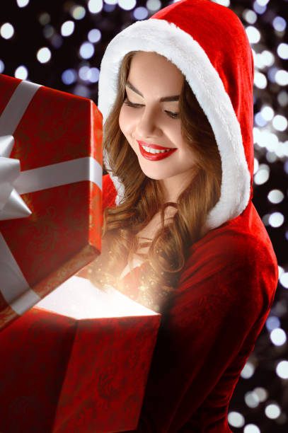 istock Smiling Snow Maiden in red suit opens a gift for New Year 2018,2019 867095066