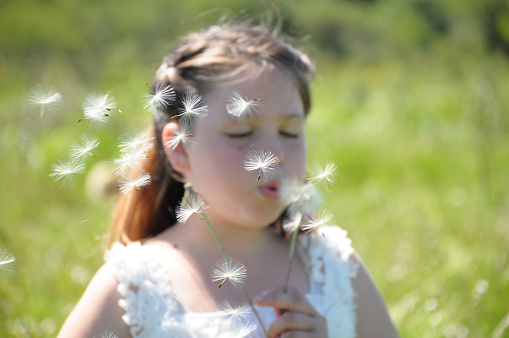 girl blowing a baker