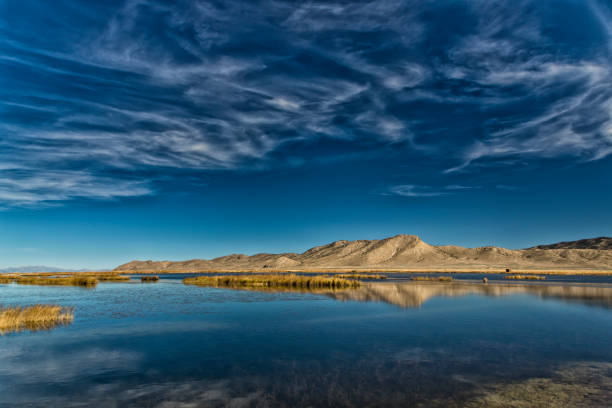 Horizontal Color Image of a mountain reflected in the waters of a Marshland