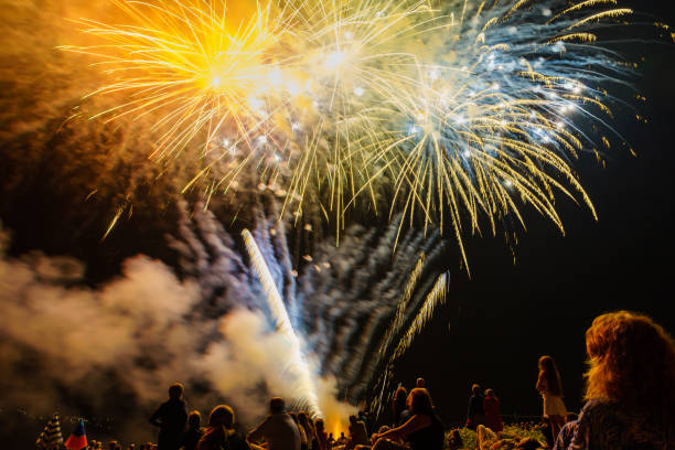 istock People sitting at the beach an watching the fireworks 867117746
