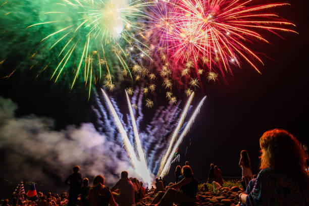 istock People sitting at the beach an watching the fireworks 867119964