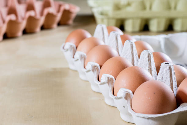 Eggs in molds on a wooden kitchen table. Hen egg in the kitchen atmosphere. black background