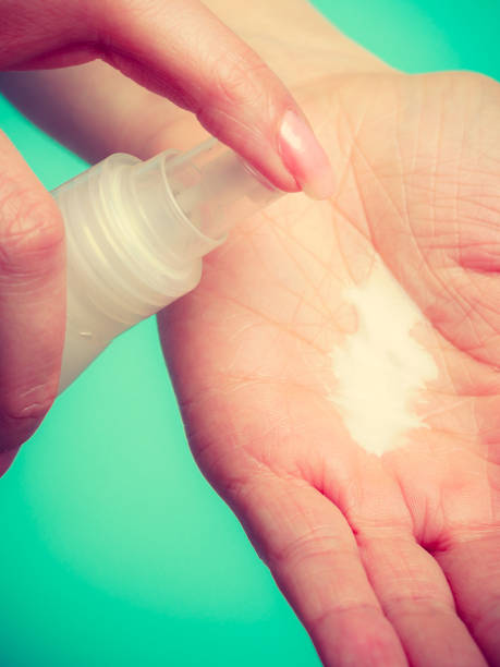 istock Woman putting white cream on hand 867120532