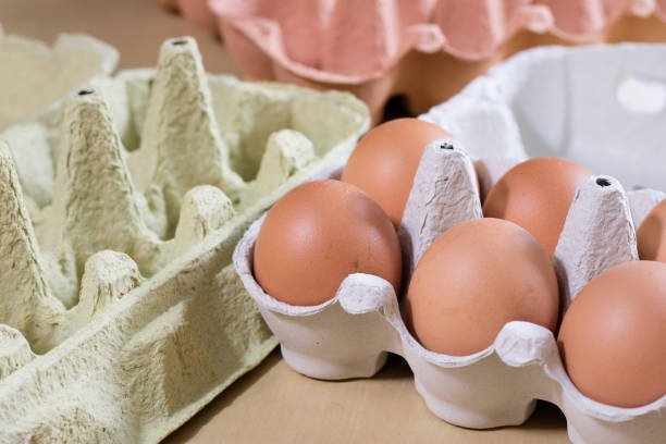 istock Eggs in molds on a wooden kitchen table. Hen egg in the kitchen atmosphere. black background 867120856