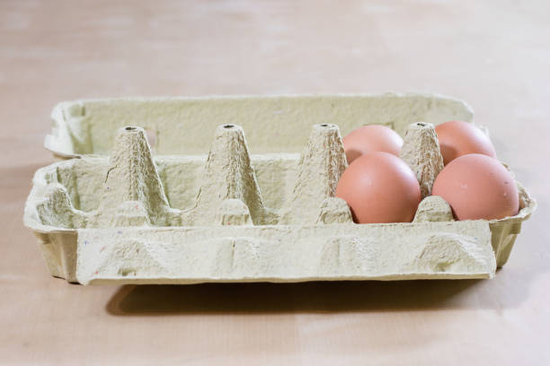 Eggs in molds on a wooden kitchen table. Hen egg in the kitchen atmosphere. black background