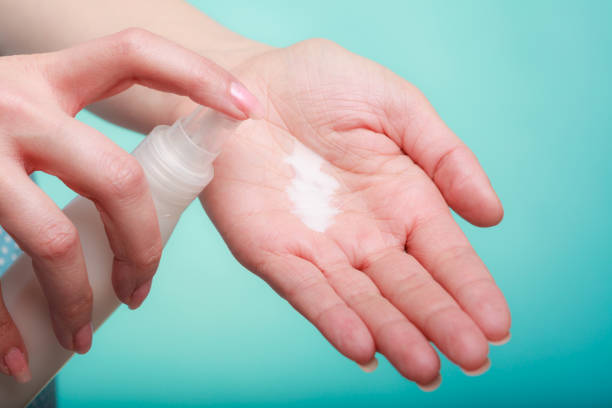 istock Woman putting white cream on hand 867127752