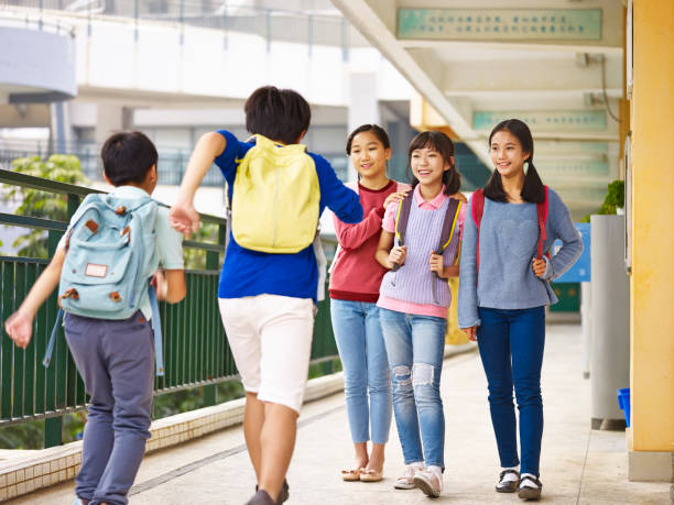 istock energetic asian pupils running in classroom building 867128910