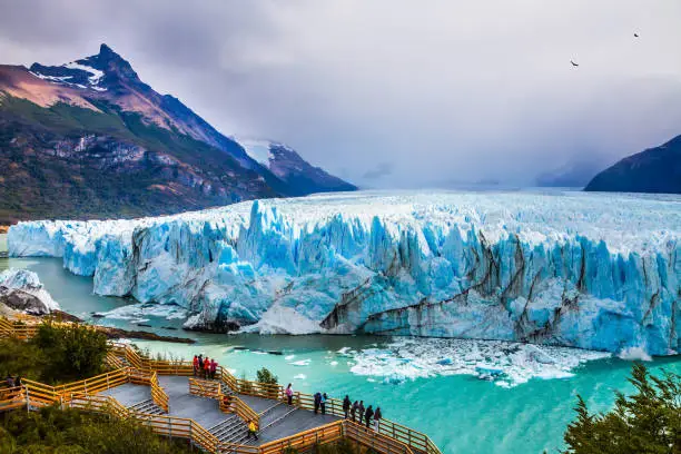 Grandiose glacier Perito Moreno in the Argentine part of Patagonia. The concept of ecological and extreme tourism. Large and comfortable observation deck for tourists