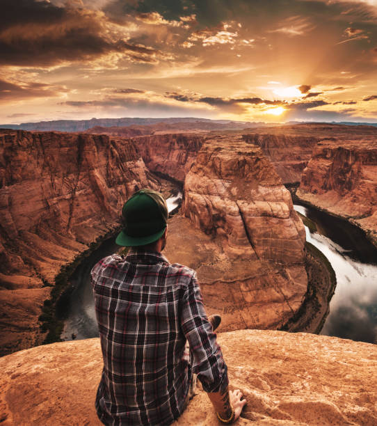 istock man resting at horseshoe bend in usa 867134084