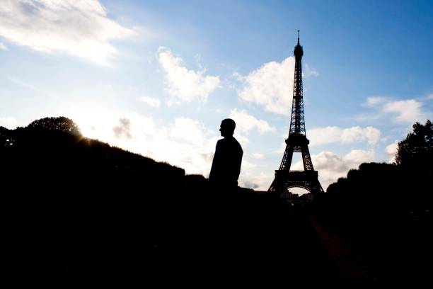 istock silhouette of a man and the Eiffel tower in the sky 867153708