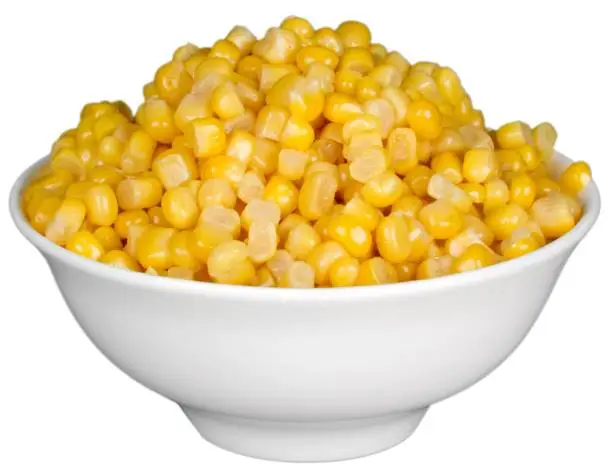 Sweet yellow corn in white bowl isolated on white background
