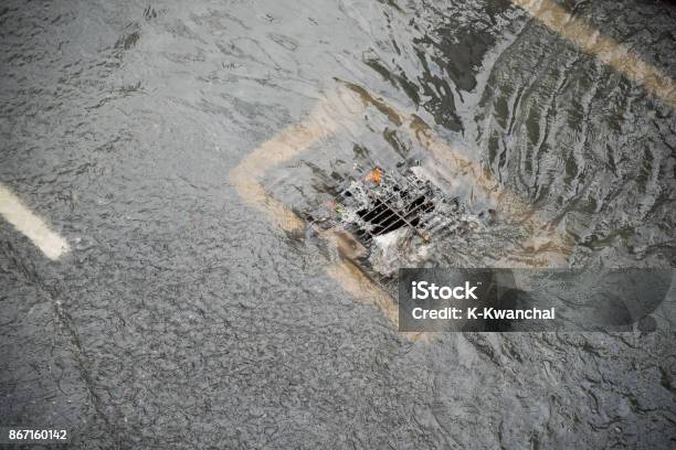 Flood After The Rain Is Flowing Down The Drain On The Road Stock Photo - Download Image Now