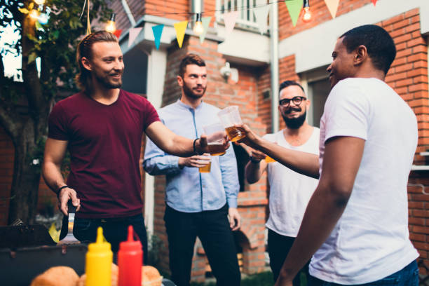 istock Male friends on a barbecue in back yard 867163310
