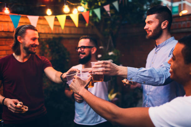 istock Male friends on a barbecue in back yard 867165932
