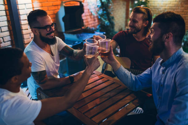 istock Male friends having fun in back yard 867166404