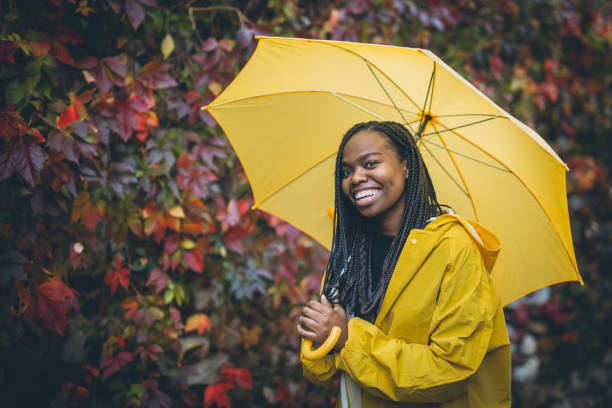 istock Young black woman in autumn walk through park 867171380