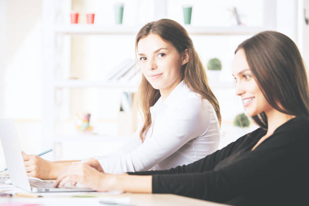 istock Gorgeous women using laptop at workplace 867171980