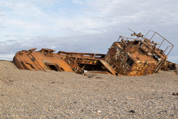 istock Old rusty boat in sand and a pebble 867182894