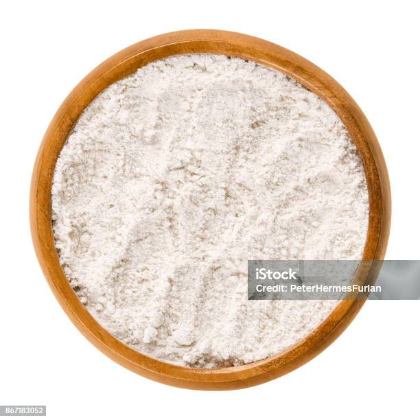 Whole Wheat Flour In Wooden Bowl Over White Stock Photo - Download Image Now - Flour, Wheat, Austria