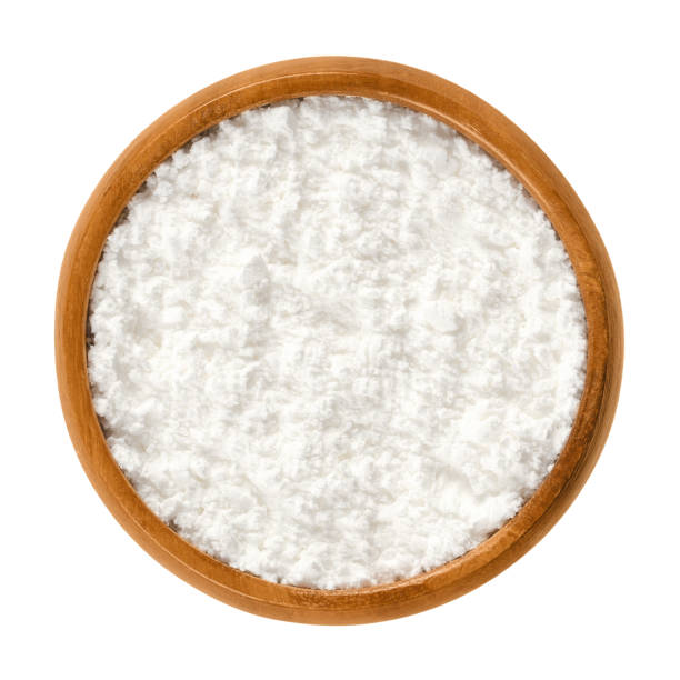 Powdered sugar in wooden bowl over white Powdered sugar in wooden bowl. Unsifted finely ground white refined sugar. Also called confectioners or icing sugar and icing cake. Isolated macro food photo close up from above on white background. decorating a cake photos stock pictures, royalty-free photos & images