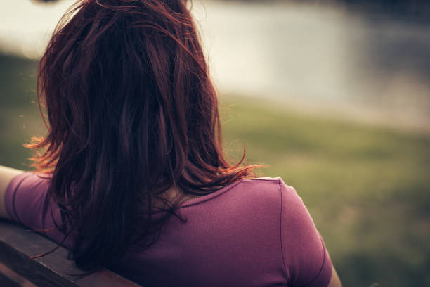 istock Girl enjoying lake view from a bench 867185782