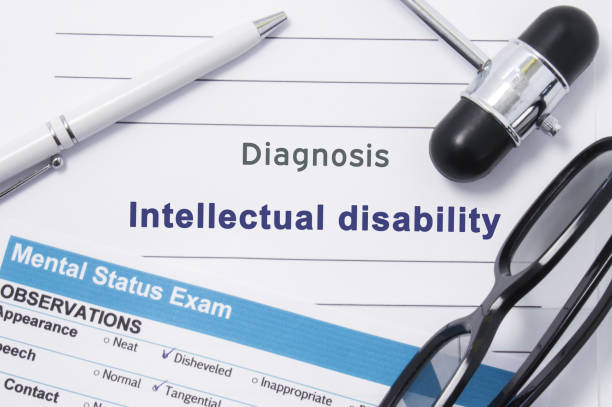 istock Diagnosis Intellectual Disability. Medical note surrounded by neurologic hammer, mental status exam with an inscription in large letters psychiatric diagnosis of Intellectual Disability 867186050