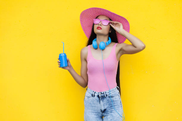istock Woman in pink outfit holding blue can 867196960