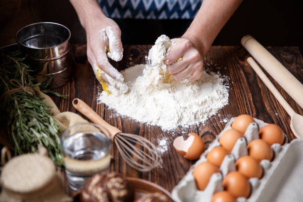 istock The man kneads the dough from flour and one egg. 867204218