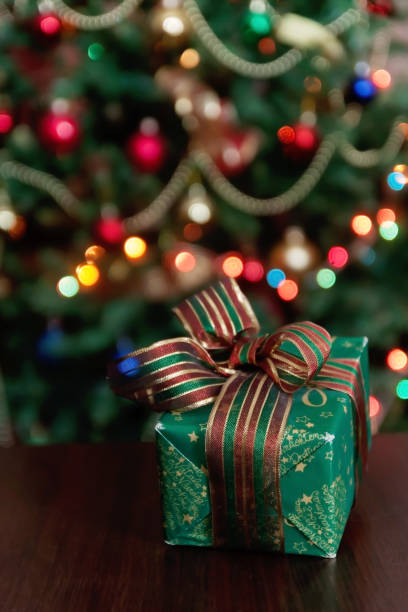 istock Gifts under the Christmas tree lights background 867206608