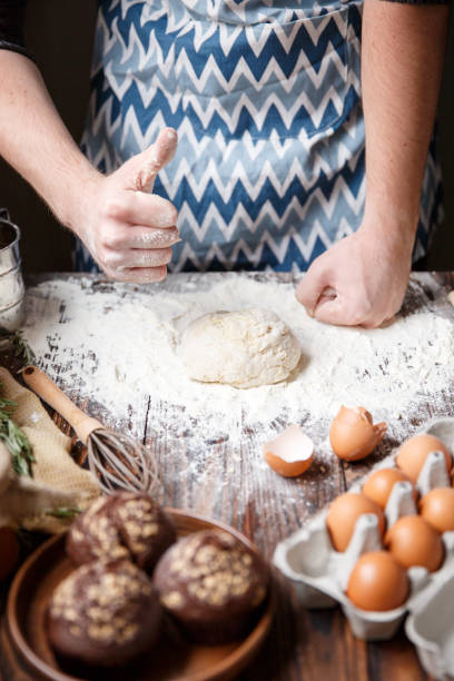 istock A man shows a gesture class near the table with flour and dough. 867207142