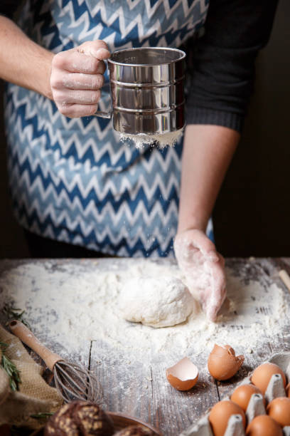 istock The cook shapes the dough and sprinkles it with flour. 867207252